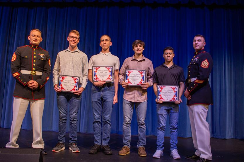 A student is honored for serving in the US Armed Forces after high school